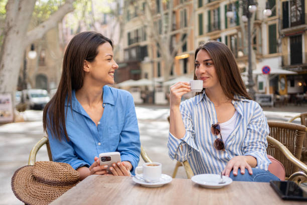 istock Two beautiful Caucasian young women drinking coffee while taking a break from touring Palma de Mallorca 2158404085