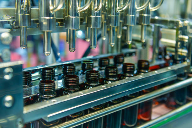 istock Glass bottles in a conveyor belt on a high quality automatic vertical filling machine. 2158405002