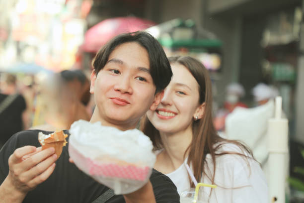 istock Couples Enjoy local food in Asia 2158406384