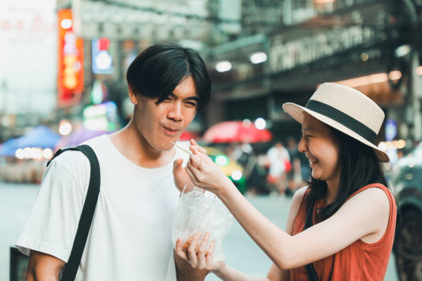 istock Couples Enjoy local food in Asia 2158406469
