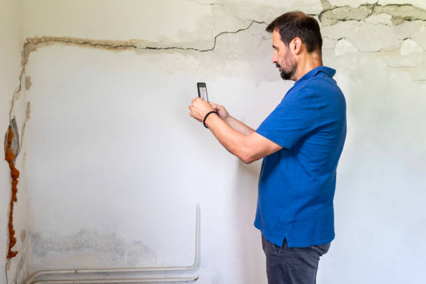 istock Mature man looking at a  damaged wall 2158406611