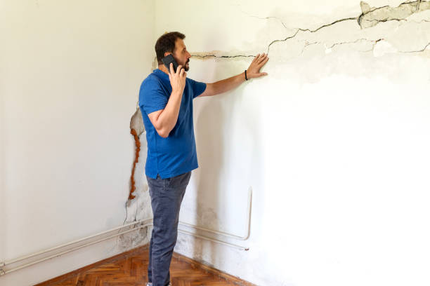 istock Mature man looking at a  damaged wall 2158406614