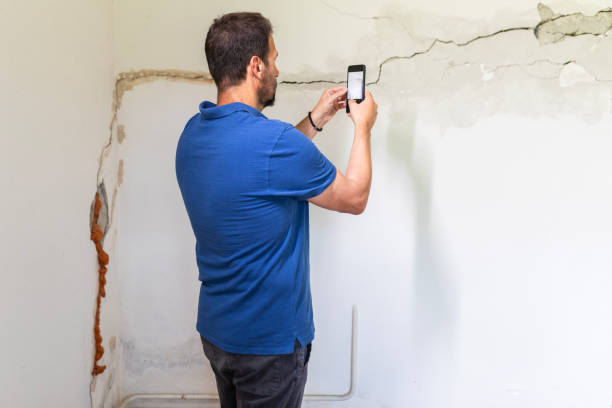 istock Mature man looking at a  damaged wall 2158406624
