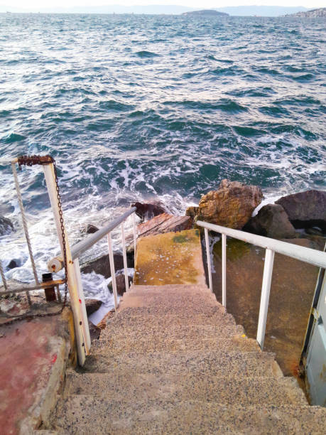Scenic view of wooden staircase leading to a peaceful beach