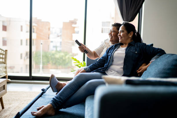 istock Lesbian couple watching tv at home 2158408413