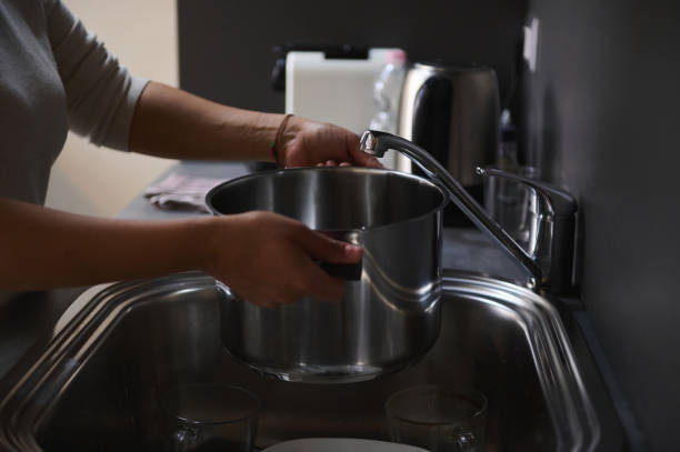 istock Person filling pot with water at kitchen sink 2158408922