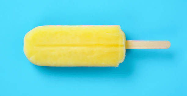 istock Close up of a yellow popsicle on the light blue background. 2158411035