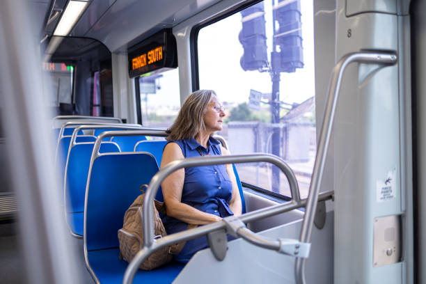 istock Woman on train looking out window during commute 2158411494