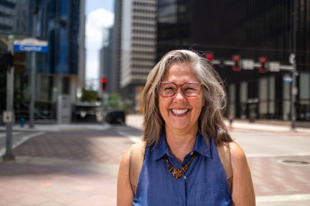 istock Happy elderly woman in urban setting 2158411540