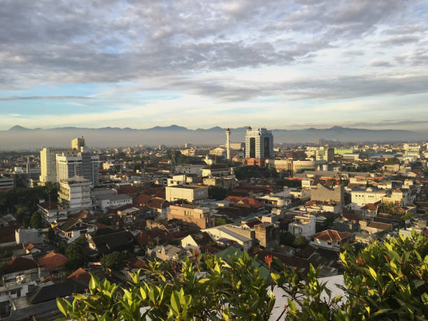 Aerial view shot of High Rise Buildings in Bandung standing next to housing area. Concept : Asia Pacific's developing countries, rich-poor gap shown on cityscape geography