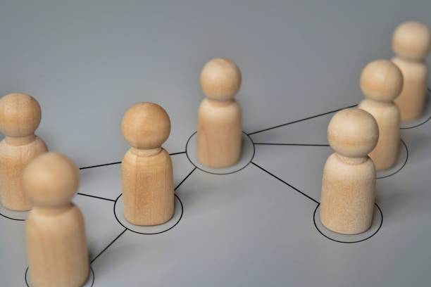 istock Wooden dolls connected by lines. 2158418942