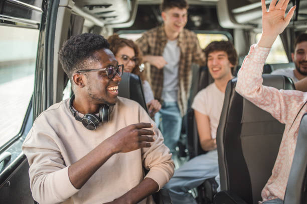 istock A diverse group of friends enjoy singing and dancing during a bus trip 2158424407