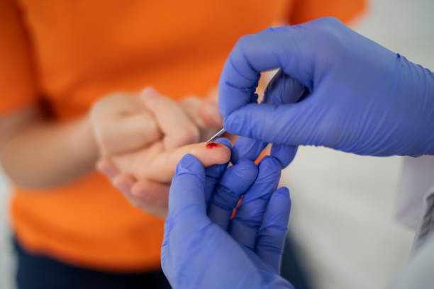 Woman doctor taking blood sample to check blood sugar level of teenage patient