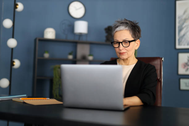 istock Experienced businesswoman working at her computer, demonstrating professionalism and technology in a modern workspace. 2158428260