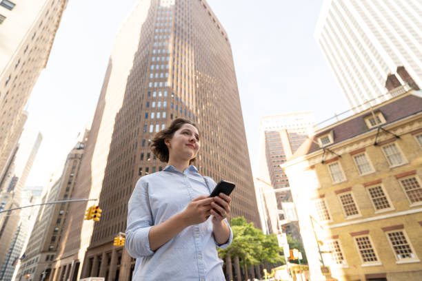 istock Confident woman with technology in the city 2158429400