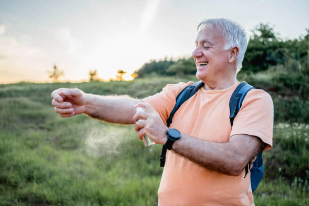 istock Senior man applying anti-mosquito repellent 2158429557