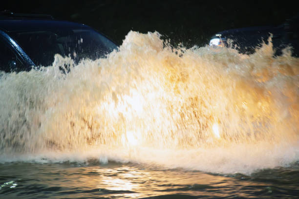 Dynamic night shot of churning river rapids illuminated by warm, golden light reflections. Ideal for showcasing power, energy, and natural beauty in marketing or editorial projects