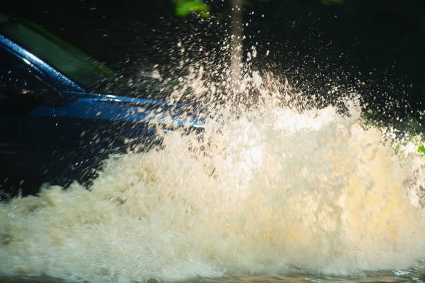 A car drives through flood waters after record setting rainfall.