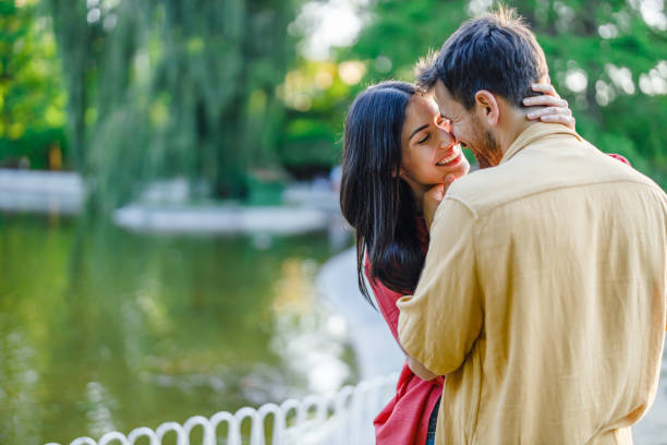 young man and woman together in the park are walking, chatting and having fun.