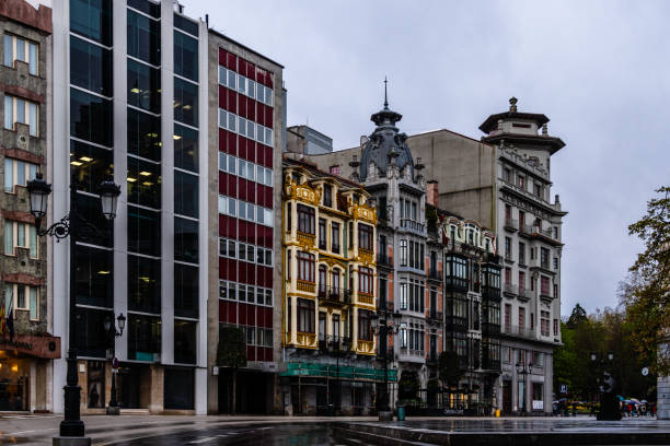 Oviedo, Spain - March 27, 2024: Cityscape of Oviedo a rainy spring day. Pedestrian street