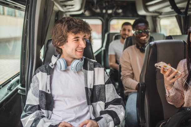 istock A group of students sit on their seats in a minibus while traveling together on vacation 2158434033
