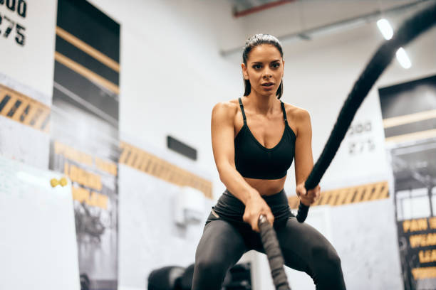 istock Active female doing a cardio workout, using two ropes, at the gym. 2158434208