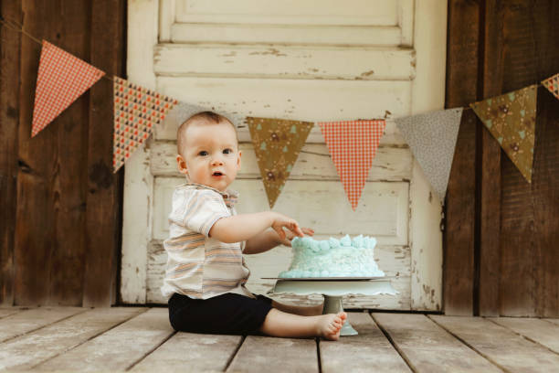 istock One Year Old Baby Boy With His Birthday Cake 2158435952