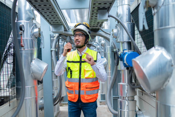 istock Engineer Inspecting Industrial Machinery with Tablet 2158435996