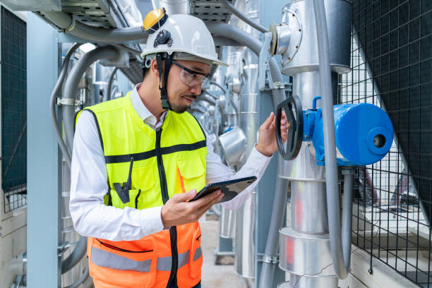 istock Engineer Inspecting Industrial Machinery with Tablet 2158435999