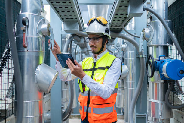 istock Engineer Inspecting Industrial Machinery with Tablet 2158436019