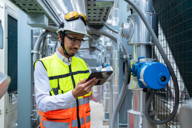 istock Engineer Inspecting Industrial Machinery with Tablet 2158436028
