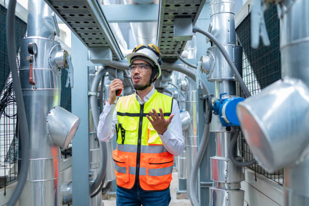 istock Engineer Inspecting Industrial Machinery with Tablet 2158436034