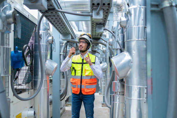 istock Engineer Inspecting Industrial Machinery with Tablet 2158436050