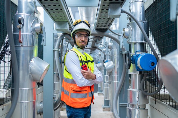 istock Engineer Inspecting Industrial Machinery with Tablet 2158436058