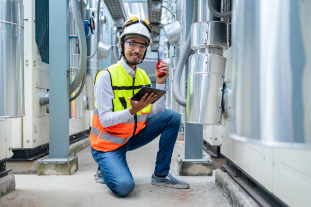 istock Engineer Inspecting Industrial Machinery with Tablet 2158436139