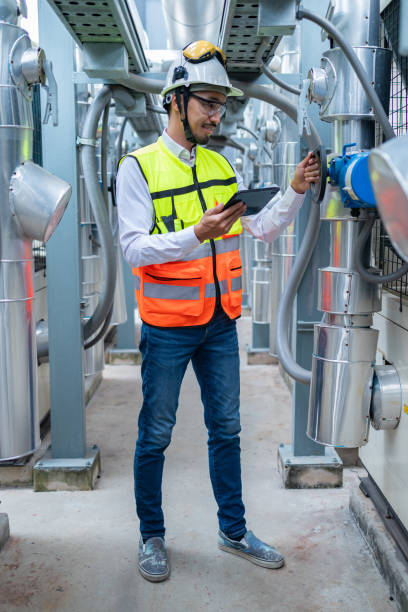 istock Engineer Inspecting Industrial Machinery with Tablet 2158436141
