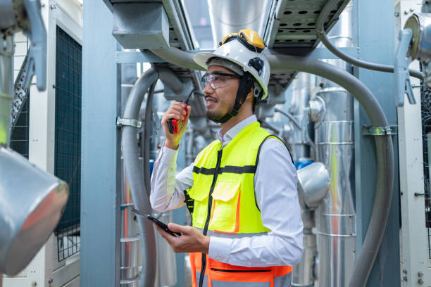 istock Engineer Inspecting Industrial Machinery with Tablet 2158436165