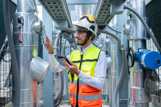istock Engineer Inspecting Industrial Machinery with Tablet 2158436185