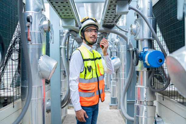 istock Engineer Inspecting Industrial Machinery with Tablet 2158436213