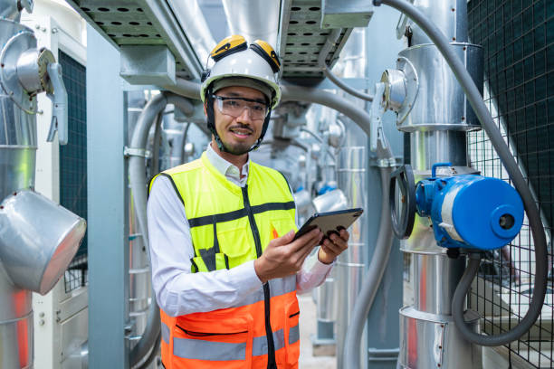 istock Engineer Inspecting Industrial Machinery with Tablet 2158436222