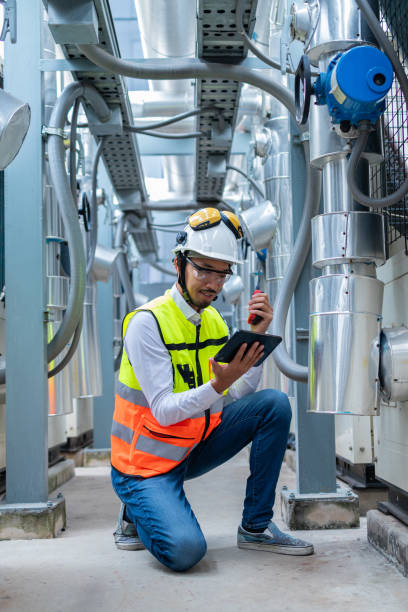 istock Engineer Inspecting Industrial Machinery with Tablet 2158436233