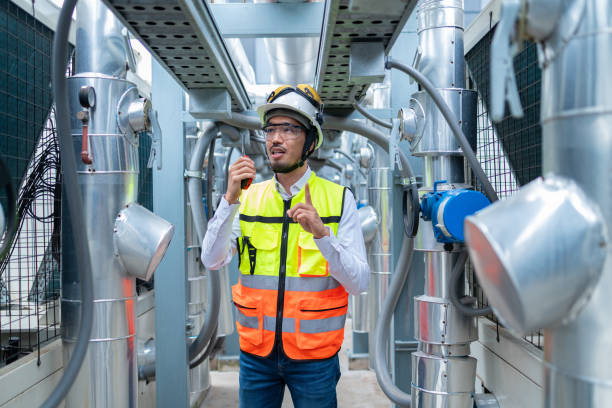 istock Engineer Inspecting Industrial Machinery with Tablet 2158436252