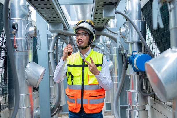 istock Engineer Inspecting Industrial Machinery with Tablet 2158436261