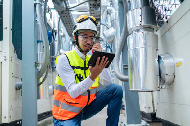 istock Engineer Inspecting Industrial Machinery with Tablet 2158436334