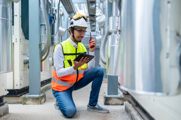 istock Engineer Inspecting Industrial Machinery with Tablet 2158436357