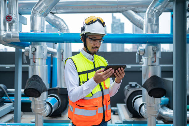 istock Engineer under checking the industry chilled water fan coil unit air conditioner is water cooling tower air chiller HVAC system of large industrial building to control air system 2158436587