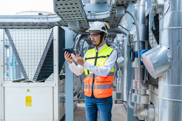 istock Engineer Inspecting Industrial Machinery with Tablet 2158436695
