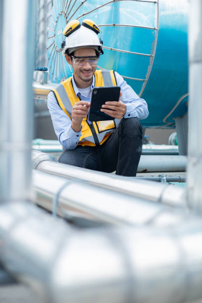 istock Engineer under checking the industry chilled water fan coil unit air conditioner is water cooling tower air chiller HVAC system of large industrial building to control air system 2158437295