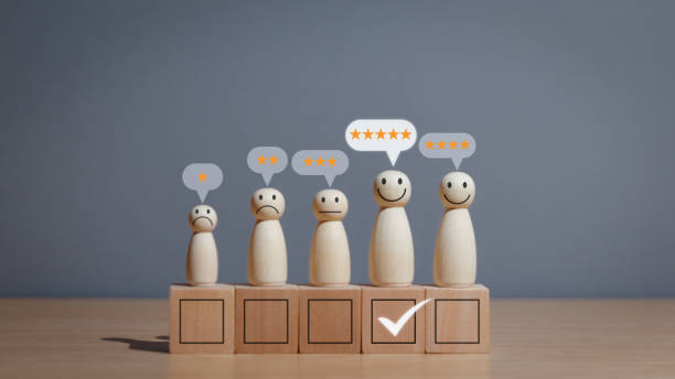 istock Wooden puppet on table, smiley face with check mark and star icon Comment on satisfaction rating or good experience and positive feedback, concept of satisfaction and customer service 2158437642