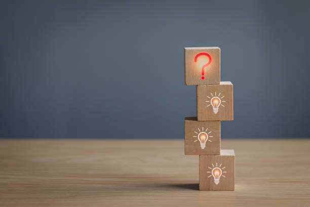 istock Wooden block at red question mark on table, concept of problem analysis, creativity analytical thinking process Or find out the cause that occurs during the work process 2158437970